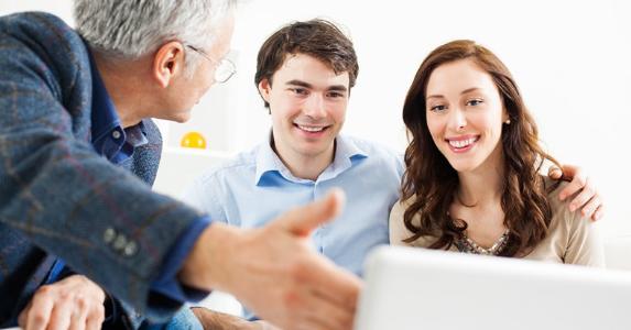 Adviser showing data to young couple © iStock